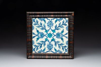 A framed blue, white and turquoise Iznik pottery tile with floral design, Turkey, 17th C.