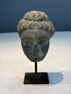 A Gandhara grey schist relief fragment of a Bodhisattva head, 3rd/4th C. — photo 1