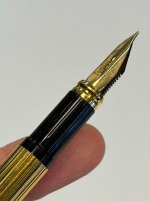 A gold-plated twist ballpoint pen and a fountain pen with an 18kt gold nib, S.T. Dupont Paris, France, 20th C. — photo 5