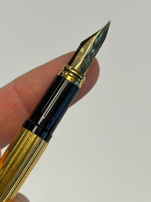 A gold-plated twist ballpoint pen and a fountain pen with an 18kt gold nib, S.T. Dupont Paris, France, 20th C. — photo 6