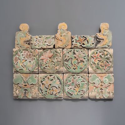 A group of 13 Chinese painted pottery relief tiles , Ming