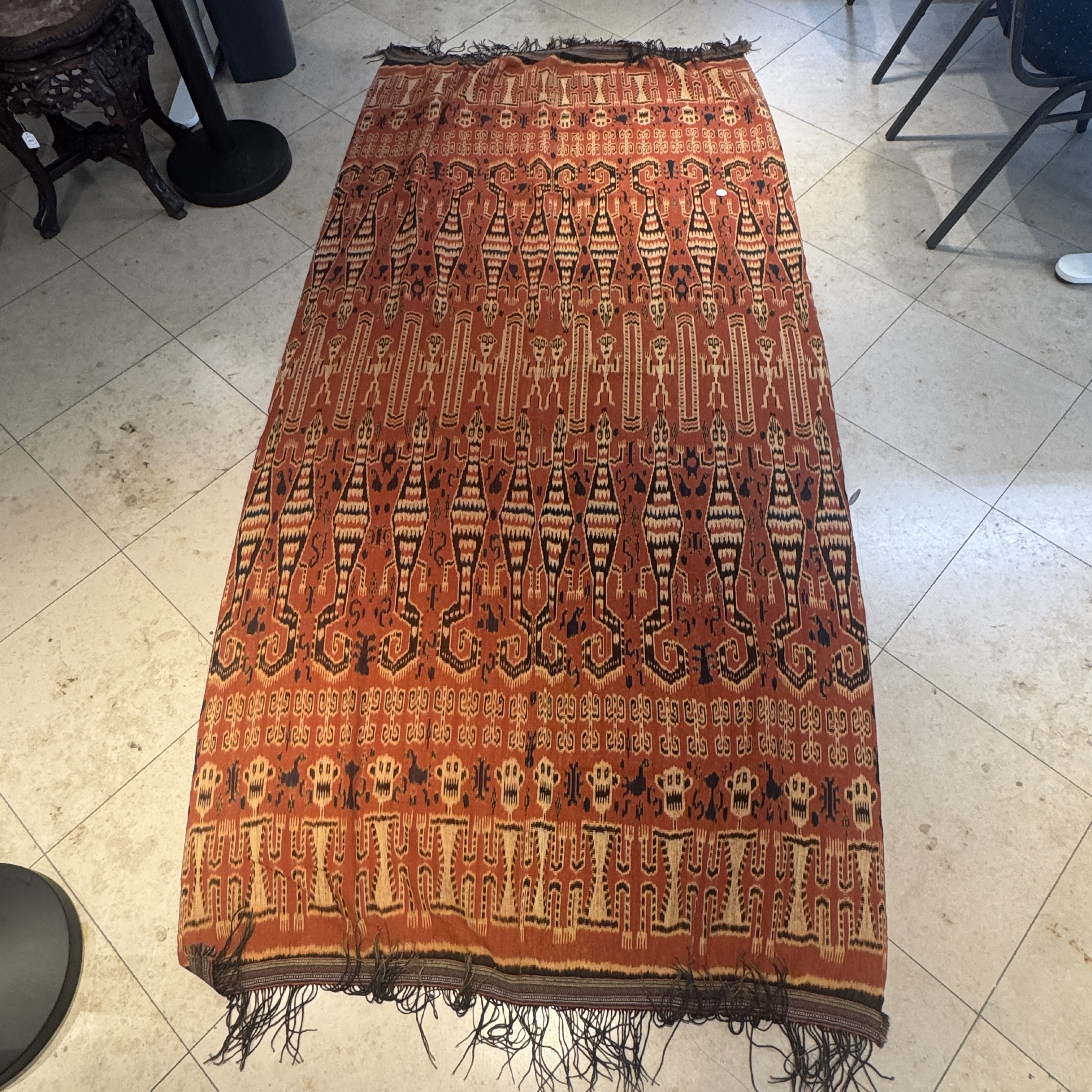 A hinggi shoulder cloth with warrior motifs and an Iban pua textile with human and animal motifs — photo 1