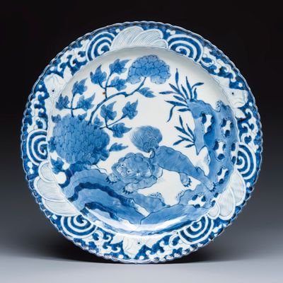A Japanese Arita blue and white 'Shishi' dish, Meiji, 19th C.