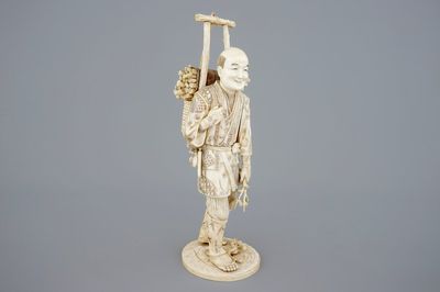 A Japanese carved ivory figure of a lumberjack, Meiji, 19th C.