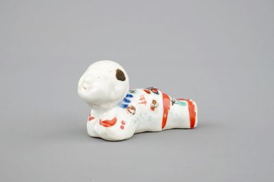 A Japanese kakiemon style whistle in the shape of a boy, 17/18th C