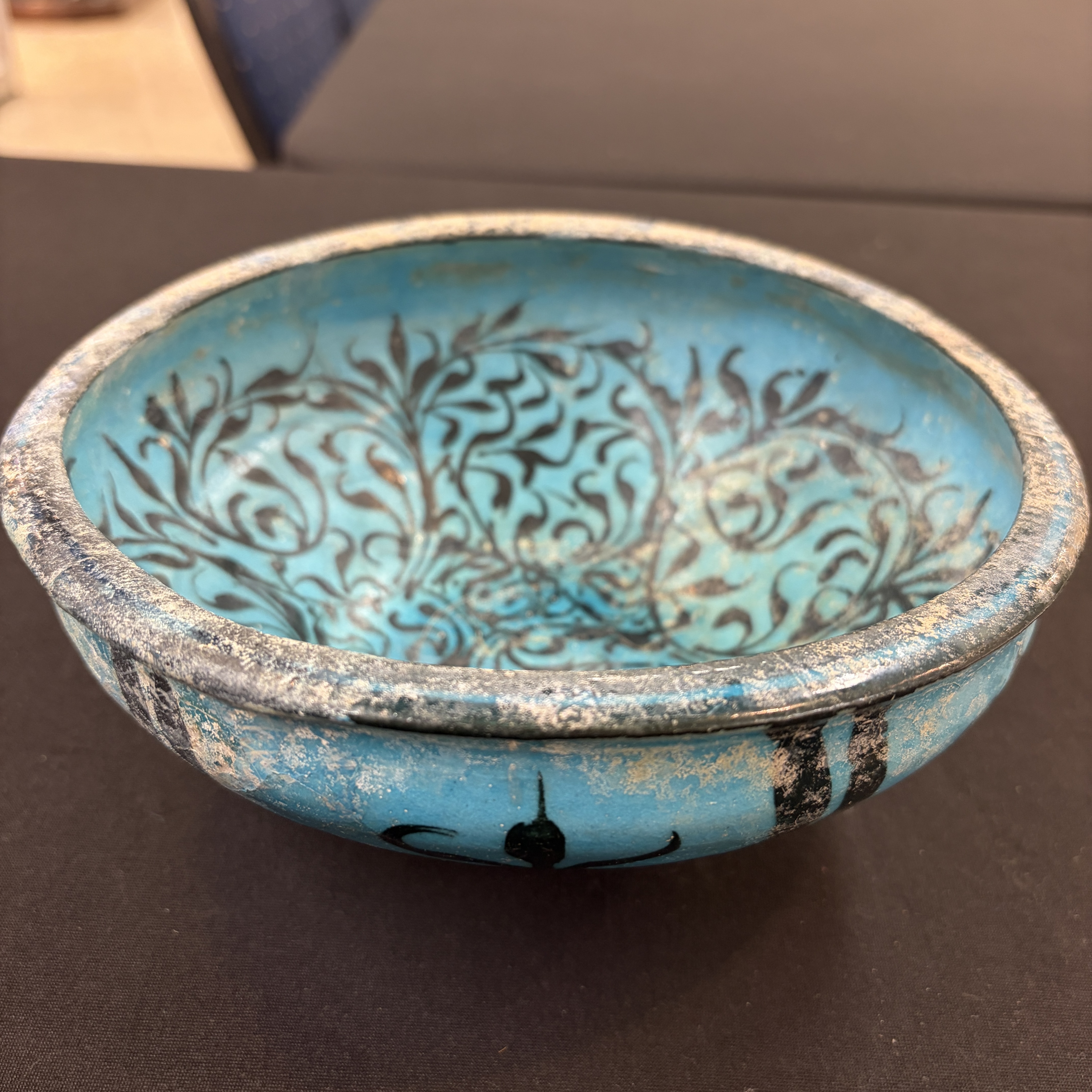 A Kashan black and turquoise pottery bowl with water-weed design — photo 1