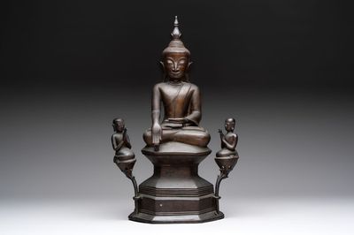 A large and fine Burmese bronze Buddha with two servants, 16/17th C.