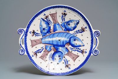 A large blue and manganese Frisian Delft fish strainer, Tichelaar, Makkum, 19th C.
