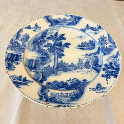 A large blue and white Dutch Delft chinoiserie dish with landscape and figural design — photo 1