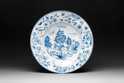 A large blue and white 'landscape and figures' dish, Frankfurt, 17th C.