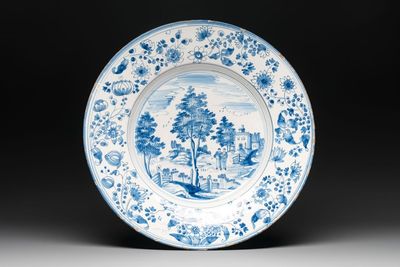 A large blue and white 'landscape and figures' dish, Frankfurt, 17th C.