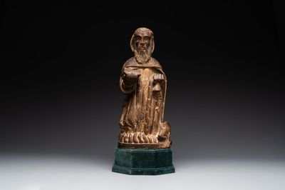 A large Burgundian stone sculpture of Saint Anthony the Great with attributes, France, 14th C.