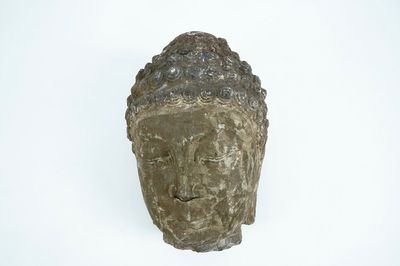 A large carved grey stone head of Buddha, China or Tibet, poss. 16/17th C.