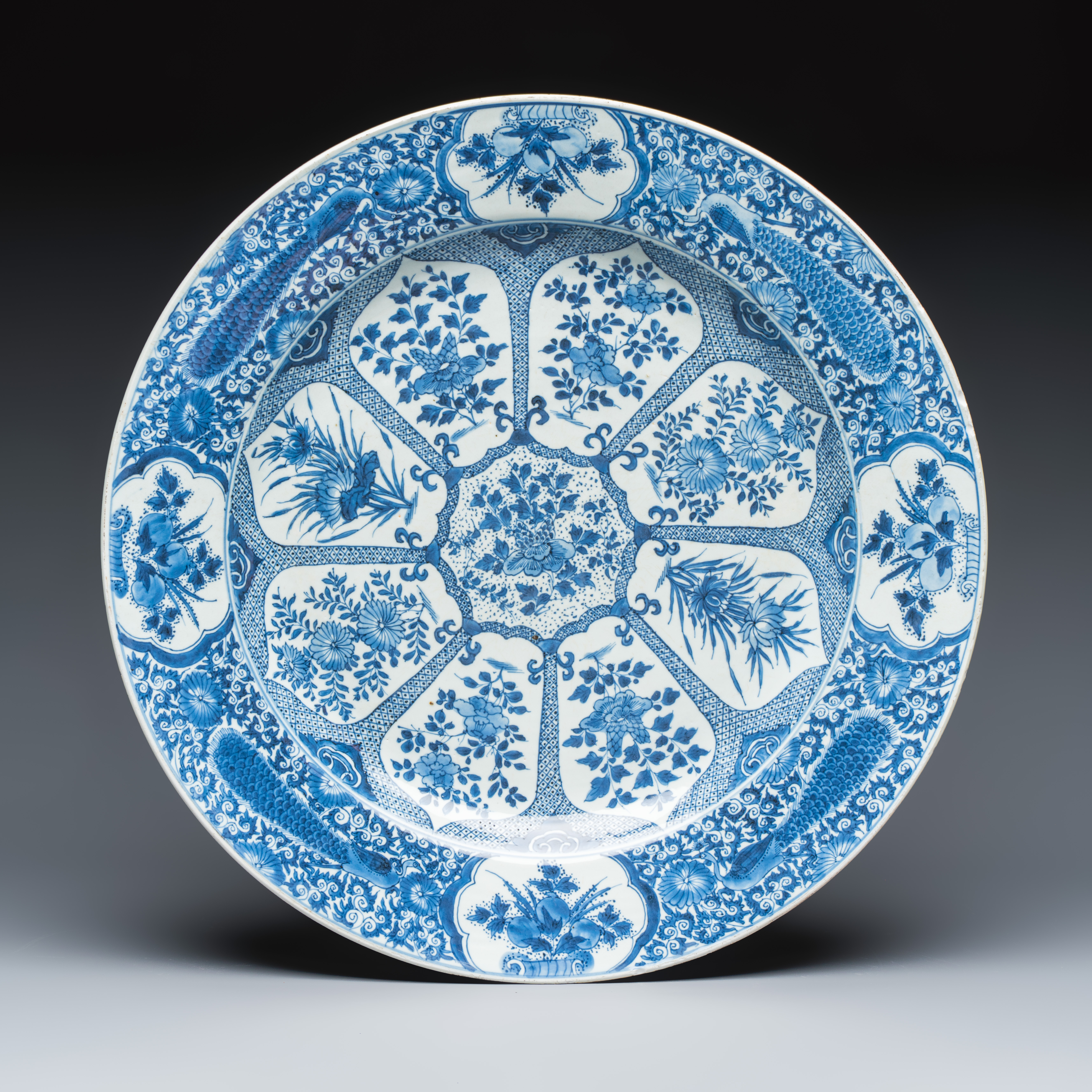 A large Chinese blue and white 'Peacock Border' dish with floral design — photo 1