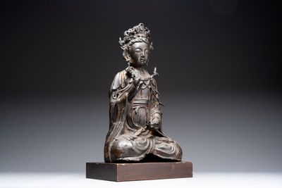 A large Chinese bronze Bodhisattva on wooden stand, Ming