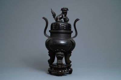 A large Chinese bronze incense burner and cover on carved wooden stand, Ming
