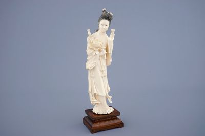 A large Chinese carved ivory figure of Guanyin on wooden base, early 20th C.