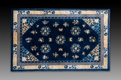 A large Chinese dark-blue-ground carpet with flowers and butterflies, 19/20th century