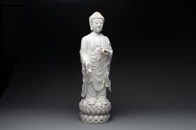 A large Chinese Dehua blanc de Chine figure of Buddha holding a lotus, He Chaozong 何朝宗 and Dehua 德化 mark, 20th C.
