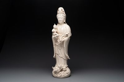 A large Chinese Dehua blanc de Chine group of a Bodhisattva with child, 20th C.