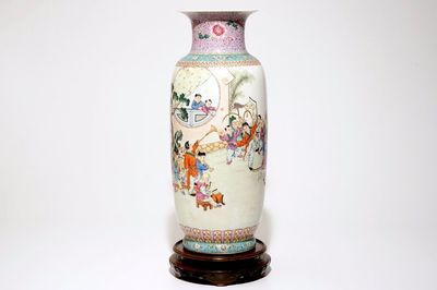 A large Chinese famille rose vase with playing boys, on a wooden stand, 20th C.
