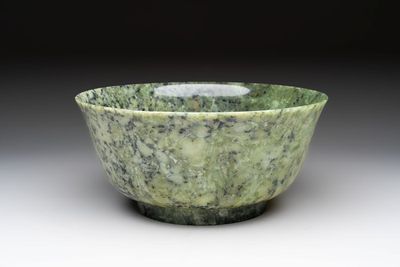 A large Chinese mottled-green serpentine bowl, 20th C.
