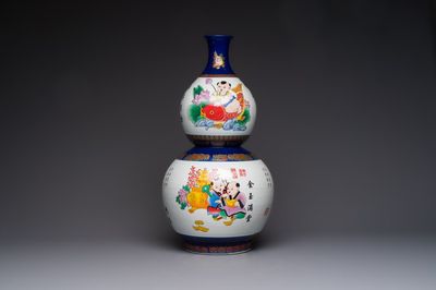 A large Chinese polychrome-decorated blue-ground double-gourd vase, 20th C.