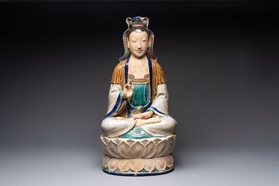 A large Chinese polychrome-glazed Shiwan stoneware figure of Guanyin, 19th C.