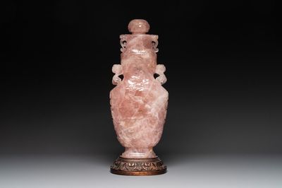 A large Chinese rose quartz vase and cover on a wooden stand, 20th C.