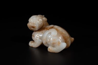 A large Chinese white and russet jade sculpture of a mythical beast, 17/18th C.