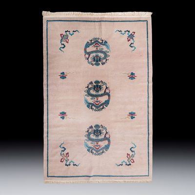 A large Chinese woollen pink-ground 'Dragon' carpet, 20th C.