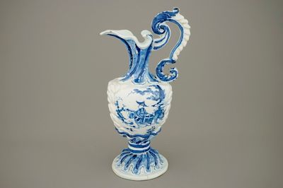 A large French faience blue and white relief-decorated jug, 18th C.