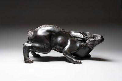 A large Japanese bronze sculpture of a reclining hare, 20th C.