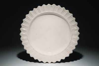 A large monochrome white relief-decorated charger, Marseille, France, 17th C.