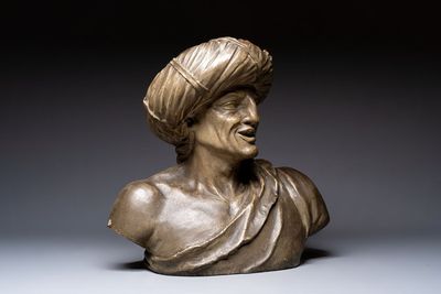 A large patinated terracotta bust of a smiling Oriental man, 18/19th C.