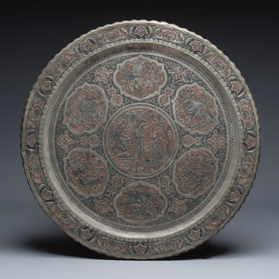 A large Persian engraved tinned-copper tray with narrative design, 19/20th C.