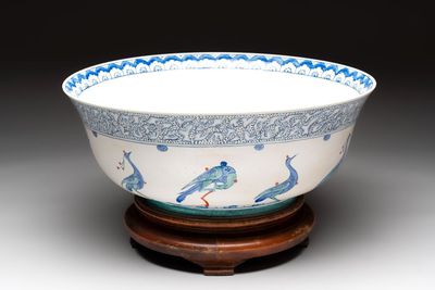 A large polychrome Iznik-style 'peacocks' bowl on a wooden stand, Samson, Paris, 19th C.
