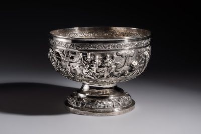 A large repoussé silver footed bowl depicting a hunting scene, India, late 19/early 20th C.