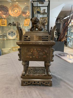 A large Vietnamese copper- and silver-inlaid rectangular 'Buddhist lion' censer and cover on stand, 19th C. — photo 1