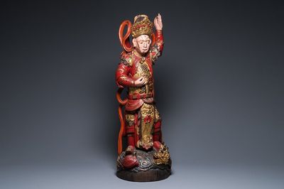 A large Vietnamese red-and-gilt-lacquered wood sculpture of a heavenly king, 19/20th C.