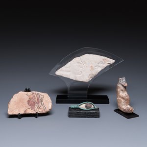 A limestone sculpture of Anubis, two sarcophagus fragments and a fragment of a carved relief, Late period — photo 1