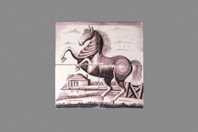 A manganese Dutch Delft four-tile panel with a rearing horse, 18th C.