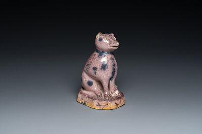 A manganese faience model of a cat, probably northern France, dated 1709