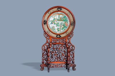 A massive Chinese carved wooden screen with a round famille verte plaque and polychrome lacquer, 19th C.