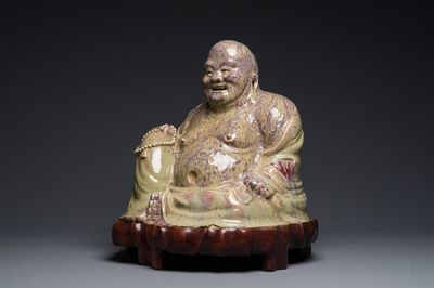 A massive Chinese flambé-glazed Shiwan pottery figure of Buddha, 18/19th C.