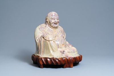 A massive Chinese flambé-glazed Shiwan pottery figure of Buddha, 18/19th C.