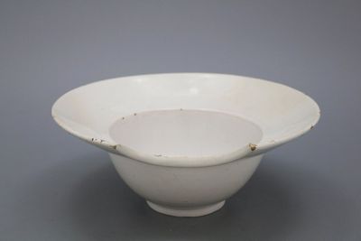 A monochrome white Dutch Delft barber's bowl, 18th C.