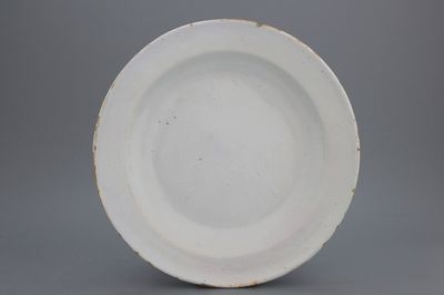 A monochrome white Dutch Delft dish of circular form, late 17th C.