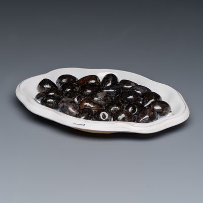 A Moustiers faience trompe-l'oeil dish with olives, France, 18th C.