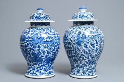 A near pair of Chinese blue and white 'phoenix' vases and covers, Kangxi